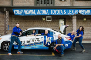 The team of Otto Service of Kansas City posing around the Otto Service Loaner car